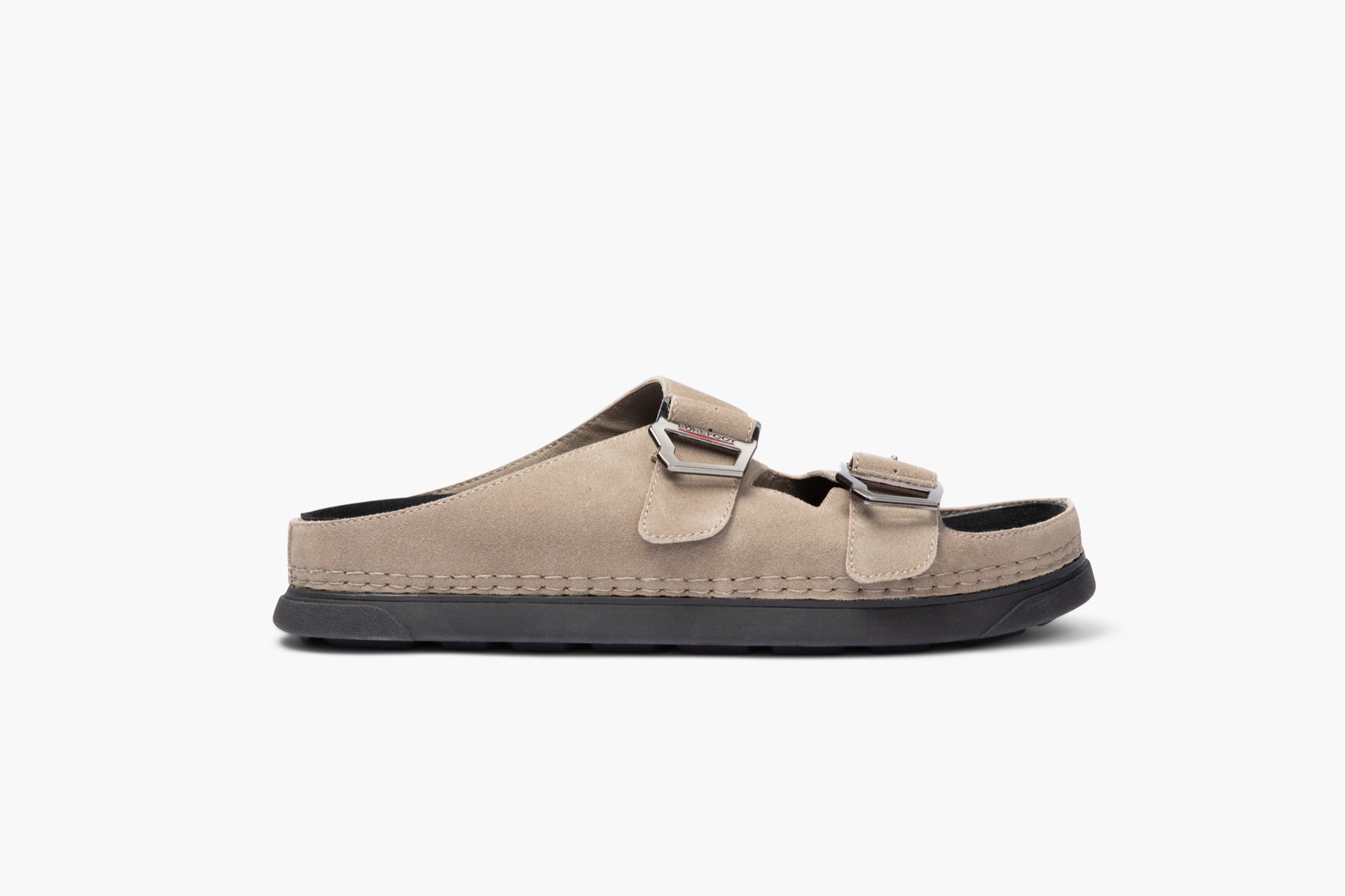 Beige sandal with black sole on a white background